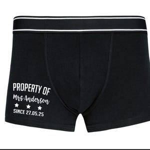 May include: Black boxer shorts with a white waistband and the text "PROPERTY OF Mrs. Anderson SINCE 27.05.25" printed on the front.