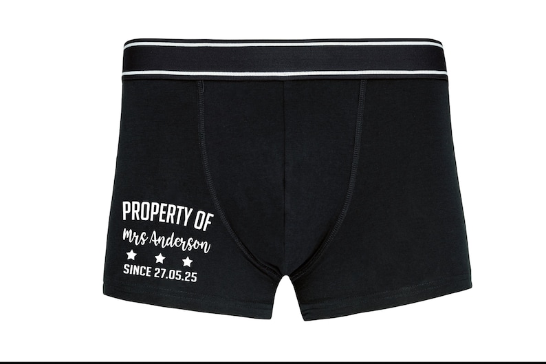 May include: Black boxer shorts with a white waistband and the text "PROPERTY OF Mrs. Anderson SINCE 27.05.25" printed on the front.