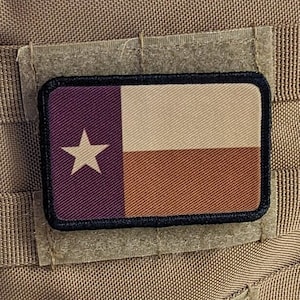 May include: A brown tactical backpack with a velcro patch featuring the Texas state flag. The flag is a dark purple, white, and orange.