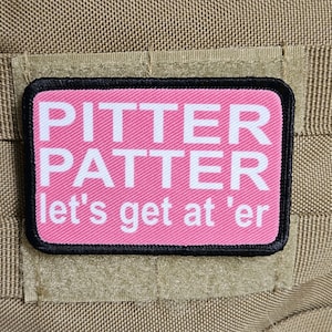 May include: Pink patch with white text that reads "Pitter Patter let's get at 'er"