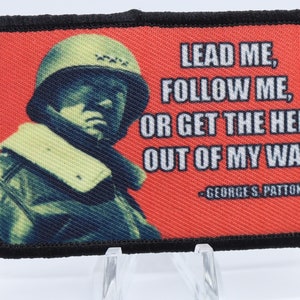 May include: A red and black fabric patch with a quote from General George S. Patton Jr. The quote reads "Lead me, follow me, or get the hell out of my way."