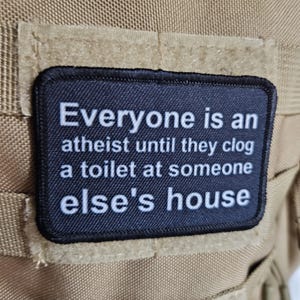 Everyone's an aetheist until they clog a toilet at somebody else's house 2"x3" removable morale patch with hook and loop backing