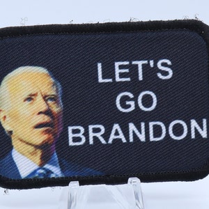 May include: A black and white embroidered patch with a photo of Joe Biden and the text "Let's Go Brandon".