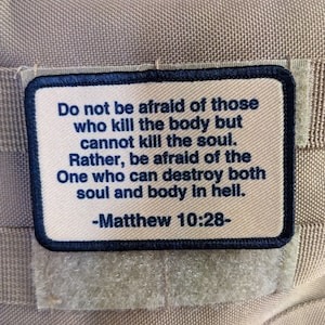May include: A beige fabric patch with black stitching and a white background. The patch features a quote from the Bible, Matthew 10:28, which reads: "Do not be afraid of those who kill the body but cannot kill the soul. Rather, be afraid of the One who can destroy both soul and body in hell."
