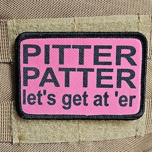 May include: Pink and black embroidered patch with the text "Pitter Patter let's get at 'er"