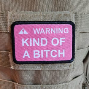 Warning kind of a bitch patch 2"x3" removable morale patch with hook and loop backing pink