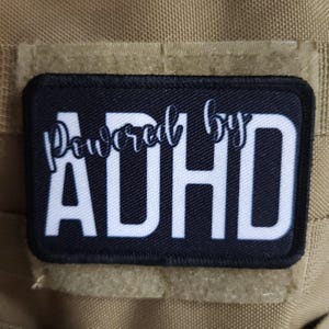 Powered by ADHD meme  2&quot;x3&quot; morale patch with hook and loop backing
