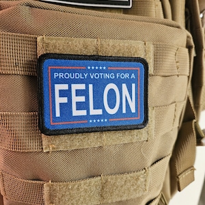 Proudly voting for a felon blue 2&quot;x3&quot; removable morale patch with hook and loop backing meme