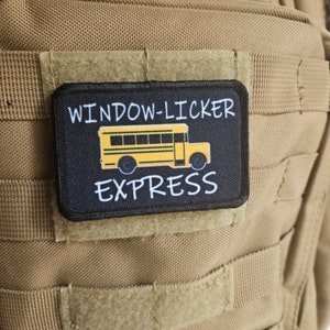 May include: A black and yellow patch with the text "Window-Licker Express" and a cartoon image of a yellow school bus.