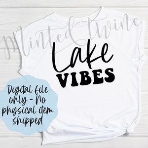 May include: White t-shirt with black text that reads "Lake Vibes".