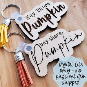 May include: Two wooden keyrings with the text "Hey there Pumpkin" and "hey there Pumpkin" in different fonts. The keyrings have brown tassels attached.