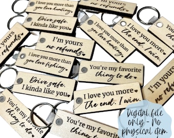 May include: A collection of wooden keychains with various engraved phrases in black, including "I love you more than you love hunting," and "You're my favorite thing to do." Each keychain has a metal ring attached.