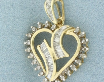 May include: A gold heart-shaped pendant with a diamond-encrusted design. The pendant features a double heart design with baguette-cut diamonds in the center and round brilliant diamonds around the edges.