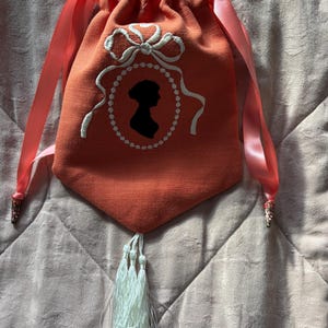 Orange linen embroidered Regency style reticule with Jane Austen silhouette and tassel