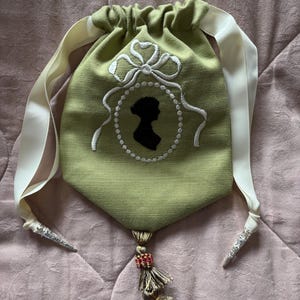 Pale olive green linen embroidered Regency style reticule with Jane Austen silhouette and tassel