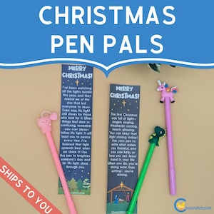 May include: Christmas-themed pen pals set. The image features three pens with decorative toppers: a pink pig, a green dinosaur, and a pink unicorn. Each pen is paired with a bookmark with a Christmas message. The background is a light yellow.