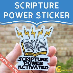 May include: A sticker with the text "SCRIPTURE POWER STICKER" at the top. The sticker features an open book with lightning bolts above it and the words "SCRIPTURE POWER ACTIVATED" below. The sticker is held by a hand.