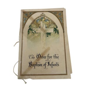 May include: A stack of vintage baptism cards. The cover features a cross design with a stained glass window effect and the text "The Order for the Baptism of Infants". The cards are tied together with a string.