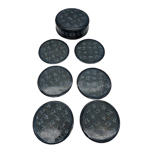 May include: Set of six black and white patterned coasters with a matching storage box. The coasters are round and have a decorative design.