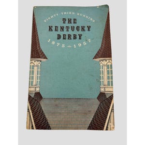 May include: A vintage program for the Eighty-Third Running of The Kentucky Derby 1875-1957. The cover features a light blue background with dark brown illustrations of two architectural towers on the sides and a paved walkway in the center.