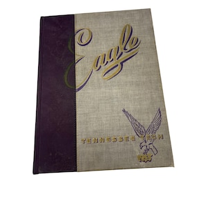 May include: A vintage hardcover book with a purple and beige cover. The cover features the word "Eagle" in gold lettering and a purple eagle graphic with the text "Tennessee Tech 1953".