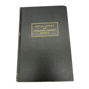 May include: A hardcover book with a dark green cover. The title "Metallurgy and Metallurgical Engineering Series" is printed in gold lettering within a gold rectangular frame. The book's spine is visible, showing a textured, aged appearance.