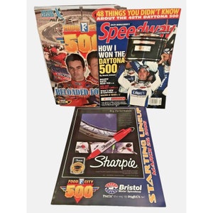 May include: Three magazines about NASCAR racing. The front cover of the magazine on the left features a red, white, and blue car with the text "Food City 500". The front cover of the magazine in the middle features a red, white, and blue car with the text "How I Won the Daytona 500". The front cover of the magazine on the right features a red, white, and blue car with the text "Speedway Illustrated".