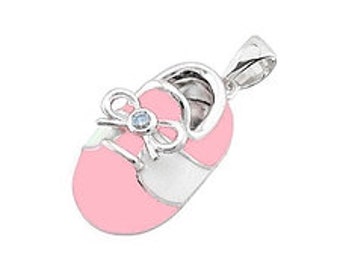May include: A silver baby shoe charm with pink and white enamel and a light blue bow with a clear stone in the center.