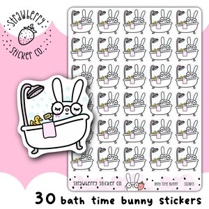 May include: A sheet of 30 bath time bunny stickers. Each sticker features a white bunny in a bathtub with a rubber ducky, soap, and a shower head. The stickers are white with black outlines and have a pink background.