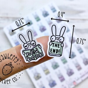 May include: Two bunny stickers, each 0.75 inches wide and 0.4 inches tall. One bunny is reading a book that says "new book" and the other bunny is reading a book that says "the end!"
