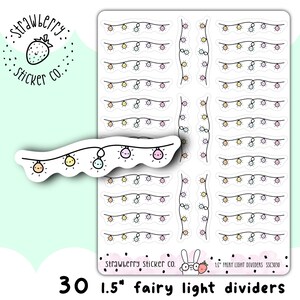 May include: Thirty 1.5 inch fairy light divider stickers. The stickers are white with a black outline and feature a string of colourful fairy lights. The stickers are perfect for planners, journals, and other paper crafts.