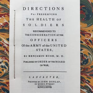May include: A vintage book page titled "DIRECTIONS For PRESERVING THE HEALTH OF SOLDIERS." The text is printed in black ink on a white page, with a marbled paper background in shades of green, yellow, and brown. The book is from Lancaster, printed in 1778.