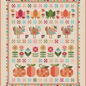 May include: A rectangular quilt featuring a cream-colored background with a repeating floral pattern. The design includes rows of appliqued autumn motifs: maple leaves, acorns, turkeys, sunflowers, flowers, and pumpkins in orange, red, and green.