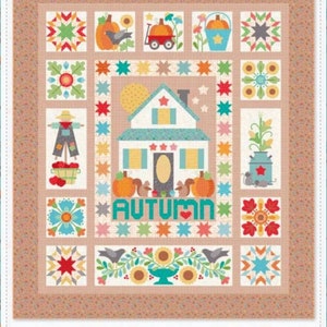 May include: A patchwork quilt with an autumn theme. The quilt features a central house design with the word "AUTUMN" below it. Surrounding the house are various squares with fall-themed images like pumpkins, squirrels, and sunflowers. The quilt has a tan border and a light blue background.