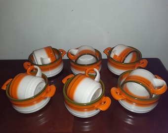 Mancer stoneware made in Italy.  Retro individual casserole dishes and soup mugs. Funky retro orange