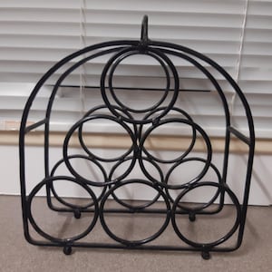 cast iron wine rack. Holds 6 bottles.