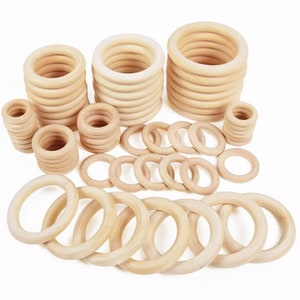 May include: A set of wooden rings in various sizes, ideal for crafting projects. The rings are made from natural wood and have a smooth finish.