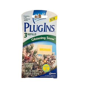 May include: A packet of PlugIns air freshener refills, 'Glistening Snow' scent. The packaging is white and blue, with the words 'PlugIns' and '3 Refills'. It also says 'Scratch-n-Sniff' and 'NEW'.