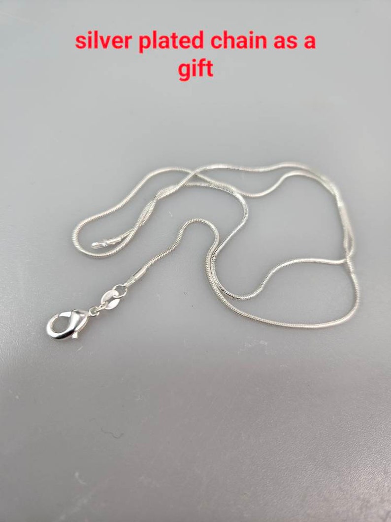 May include: A silver plated chain necklace with a lobster clasp closure.
