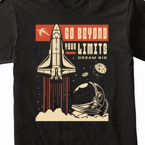 May include: Black t-shirt with a graphic of a space shuttle launching into space with the text "Go Beyond Your Limits Dream Big".