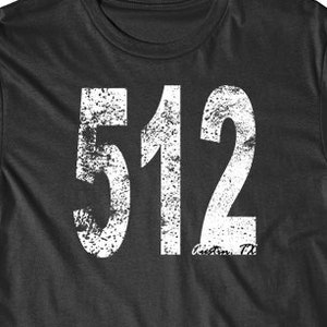 May include: A black t-shirt with a white distressed graphic of the number 512.