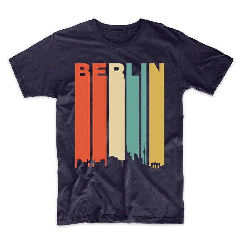 May include: A navy blue t-shirt with a retro-style skyline of Berlin, Germany. The word "BERLIN" is printed in white letters above the skyline. The skyline is made up of various buildings and a tower, all in black.