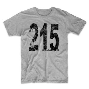 May include: A gray t-shirt with a distressed black graphic of the number 215 and the text "Philadelphia, PA".
