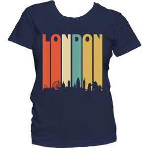 May include: A navy blue t-shirt with a retro-style graphic of the London skyline and the word "LONDON" in a colorful striped design.
