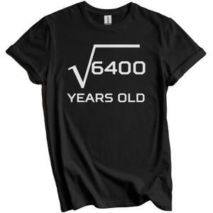 May include: Black t-shirt with white text. The text features a square root symbol over the number 6400, followed by "YEARS OLD" below. The shirt is a Gildan brand.