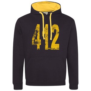 May include: Black hooded sweatshirt with a yellow hood lining. The front of the sweatshirt has a large yellow number "412" with a distressed look and the text "Pittsburgh, PA" underneath.
