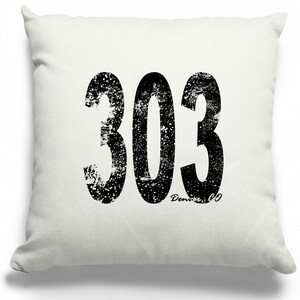 May include: White throw pillow with a black distressed graphic of the number 303 and the text "Denver, CO".