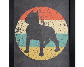 May include: A framed wall art print featuring a dark gray silhouette of a dog standing inside a distressed circular background. The circle is divided into horizontal stripes of orange, cream, teal, and yellow, all set against a dark gray backdrop.