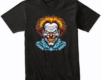 May include: Black t-shirt with a graphic of a scary clown with red hair, a big smile, and a red nose.