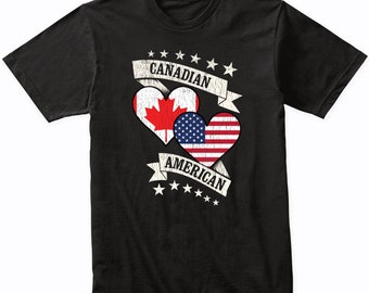 May include: Black t-shirt with a distressed graphic of two hearts. The hearts are filled with the Canadian and American flags. The text "CANADIAN AMERICAN" is written on a banner above the hearts.